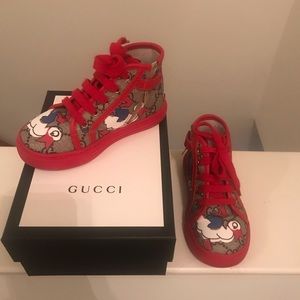 Toddler’s hi top Gucci sneakers.